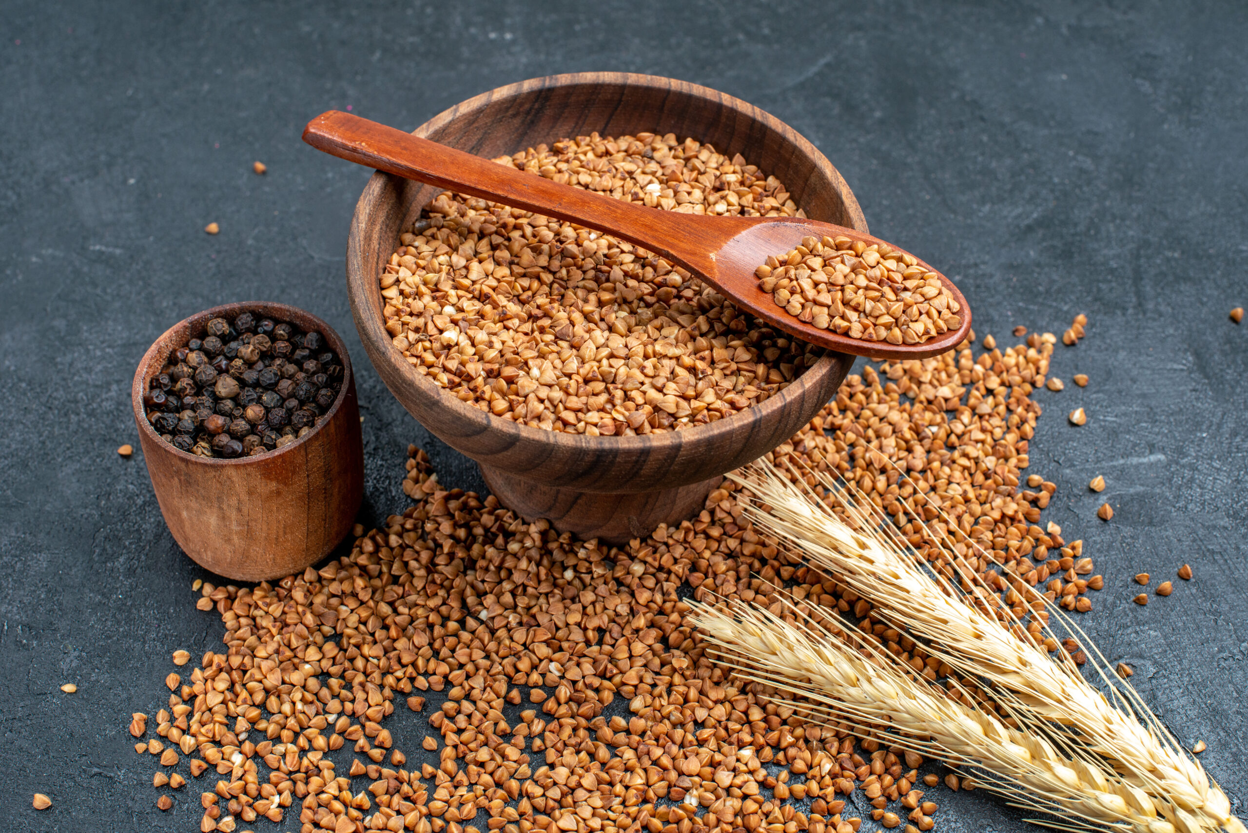 front view raw buckwheat fresh ingredients inside brown plate grey space